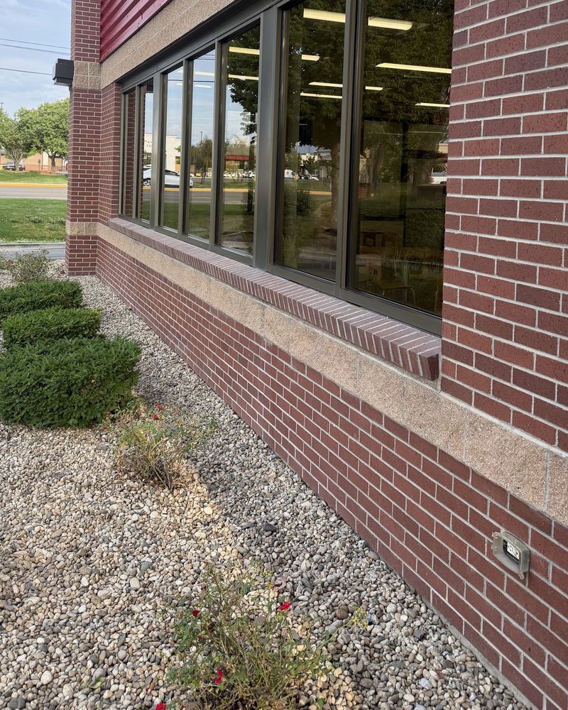 Clean storefront windows on a brick commercial building
